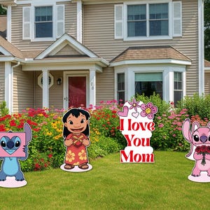 May include: Four colorful yard signs featuring characters from the animated film Lilo & Stitch. One sign reads "I Love You Mom." The signs are placed on a green lawn in front of a house with a flower garden.