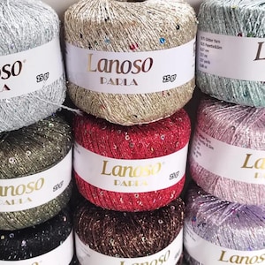 May include: A collection of Lanoso Parla glitter yarn balls in various colors including silver, gold, red, green, pink, and brown. Each ball features a white paper label with the brand name Lanoso Parla and a weight of 25 grams printed on it.