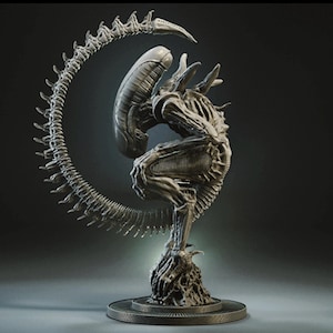 May include: A detailed sculpture of an Alien Xenomorph, featuring a curved tail and intricate skeletal details. The sculpture is metallic gray and stands on a circular base, showcasing the creature's iconic design.
