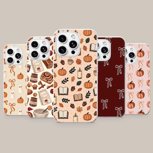 May include: Five smartphone cases arranged in a row, each featuring a distinct pattern. Designs include ghosts and pumpkins, baking ingredients, autumn motifs like leaves and books, white line-art bows on dark red, and pink with pumpkins and bows.