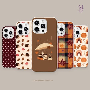 May include: Five smartphone cases featuring distinct designs: a dark red heart pattern, a cream background with hedgehogs and mushrooms, a brown case with books and an umbrella under rain, a plaid autumn leaf print, and a cream case with pumpkins and rainbows.