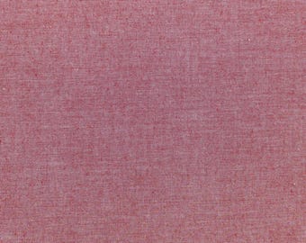 May include: A close-up of a textured, red fabric. The material has a woven appearance with a slightly uneven surface, creating a subtle visual texture. The color is a solid, medium red, with no visible patterns or designs.
