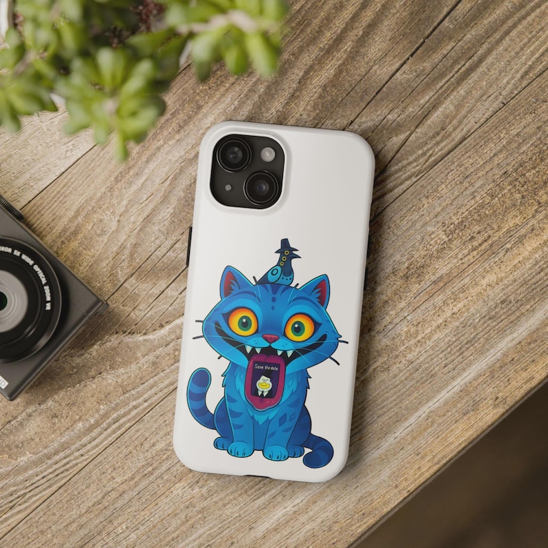May include: White phone case featuring a cartoon blue cat with yellow eyes and a bird on its head. The cat has a wide grin, and its tongue displays a graphic with the text "Save the Kids".