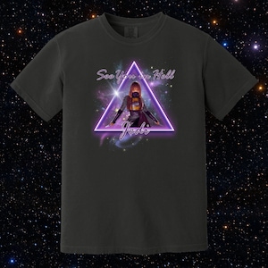 May include: Dark gray t-shirt featuring a neon purple triangle with a woman illustration and the text "See You in Hell, Jedi". The design includes a space-themed background with stars and galaxies.