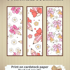 May include: Three printable bookmarks with a white background and a brown border. Each bookmark features a different design of pink bows, pencils, and flowers. The text "3 PRINTABLE BOOKMARKS" is at the top.