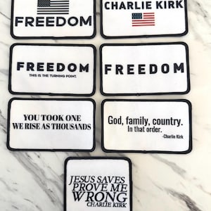 May include: A collection of white rectangular patches with black borders. Each patch features text and some with American flag graphics. Phrases include "FREEDOM", "God, family, country", and "JESUS SAVES PROVE ME WRONG".
