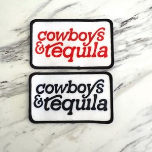 May include: Two rectangular patches with the text "cowboys & tequila". One patch has red text, the other has black text. Both patches have a white background and a black border.