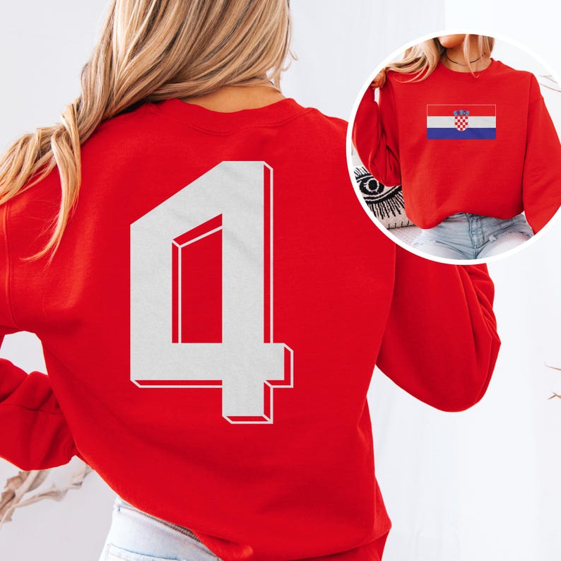 A woman wearing a red sweater with the number 4 on it, and a small image of the Croatia national flag on the back of the sweater.