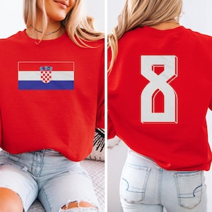 A woman wearing a red shirt with the Croatia national flag and the number 8 on the back.