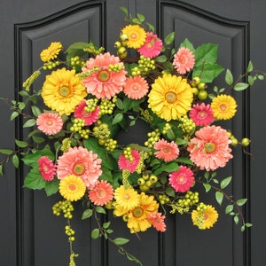 Vibrant Daisy Wreath for Spring and Summer.  Wreath colors are yellow, salmon and hot pink with greenery.