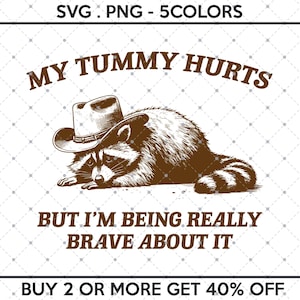 May include: A brown raccoon wearing a brown cowboy hat with the text "MY TUMMY HURTS BUT I'M BEING REALLY BRAVE ABOUT IT" and "BUY 2 OR MORE GET 40% OFF" below the raccoon.