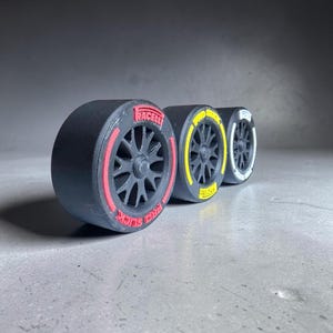 May include: A set of three ceramic mugs with a speckled, matte finish in cream, light grey, and dark grey. Each mug has a simple, minimalist design and a rounded handle.