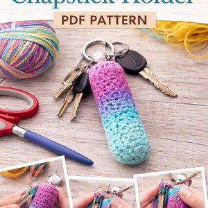 May include: A crochet chapstick holder in a gradient of pink, purple, and blue, attached to a keyring with keys. The image also shows a ball of yarn, scissors, and a pen. Text on the image says "Crochet Chapstick Holder PDF Pattern".