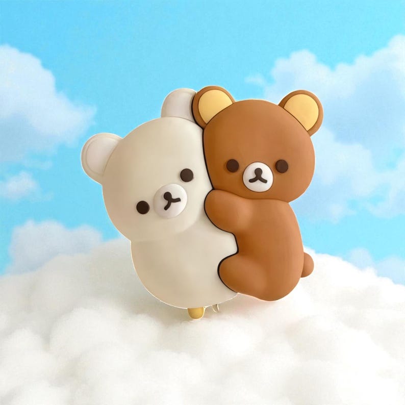 May include: A charming, cartoon-style image features two bear figures embracing. One bear is white, the other is brown, with tan ears and black eyes. They are set against a backdrop of a blue sky with fluffy white clouds, creating a whimsical scene.