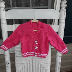 Hand Knitted - Pink Child&#39;s Sweater with White Trim and Cat (Marie) Buttons