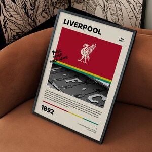 Liverpool FC Poster Framed Print: A framed Liverpool FC poster with the iconic "You'll Never Walk Alone" slogan, team logo, and Anfield stadium image.