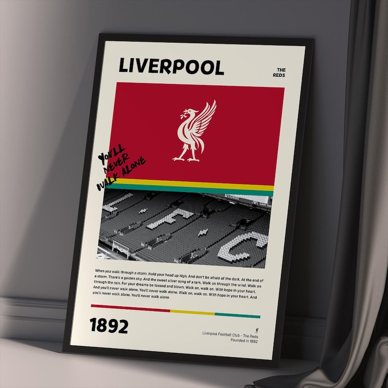 Liverpool FC Art Print with Stadium Seats: A vibrant Liverpool FC art print showcasing the "You'll Never Walk Alone" slogan, Anfield stadium photo, and the club's logo. Ideal gift for soccer fans and supporters of the Reds.