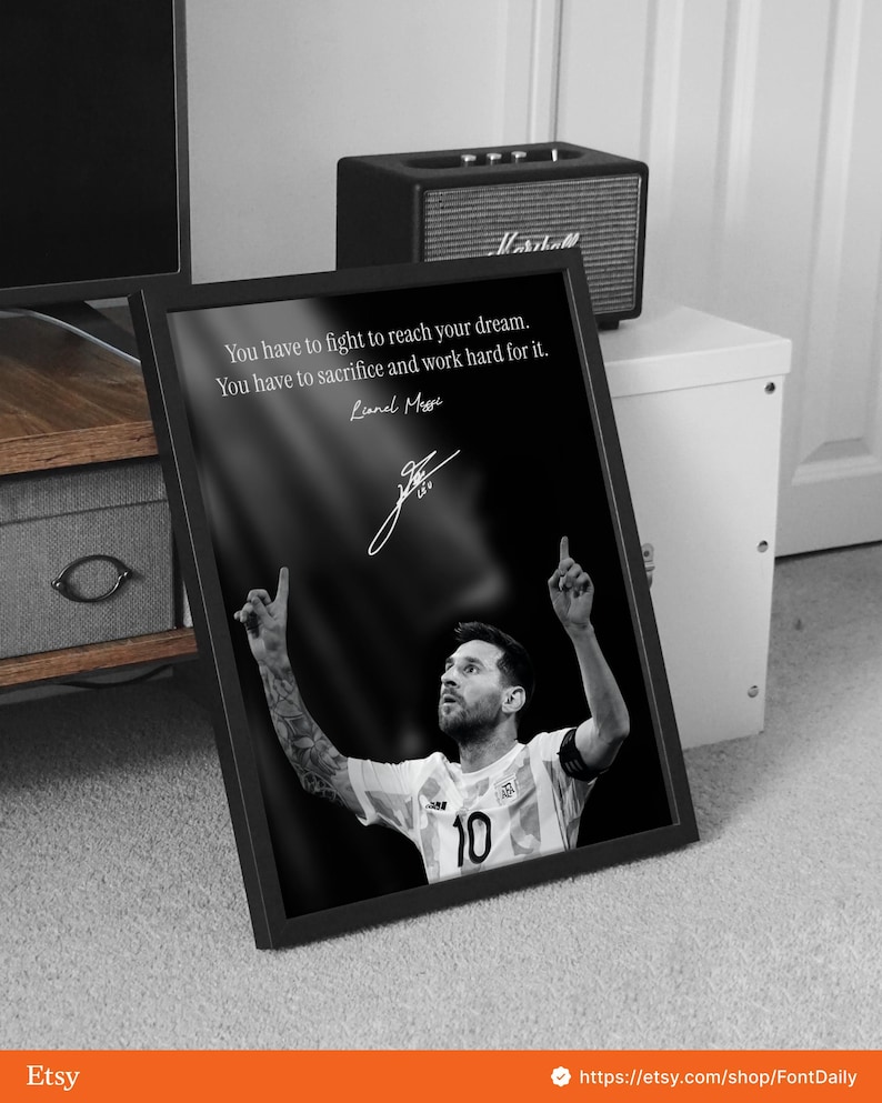 May include: Black and white framed print featuring Lionel Messi. The image shows Messi in a soccer uniform with the number 10, arms raised. The print includes a quote by Messi: "You have to fight to reach your dream."