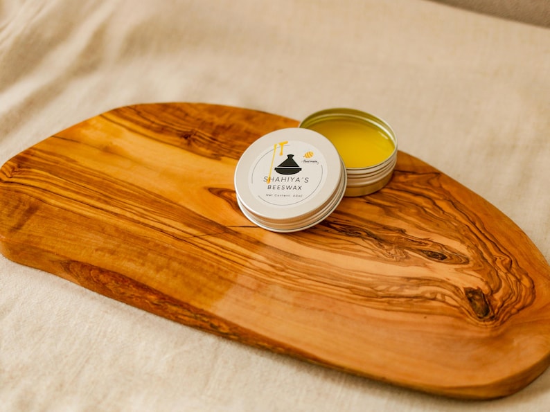 Shahiya Beewax 
Elegant olive wood chopping board with engraved customization. Hand-finished for beauty and durability, ideal for Mediterranean-inspired kitchens.
