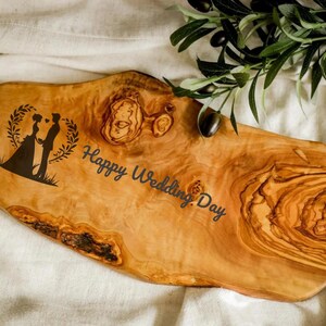 Handcrafted olive wood cutting board, custom engraved for a personal touch. Perfect for chopping, serving, or displaying in a rustic kitchen setting.