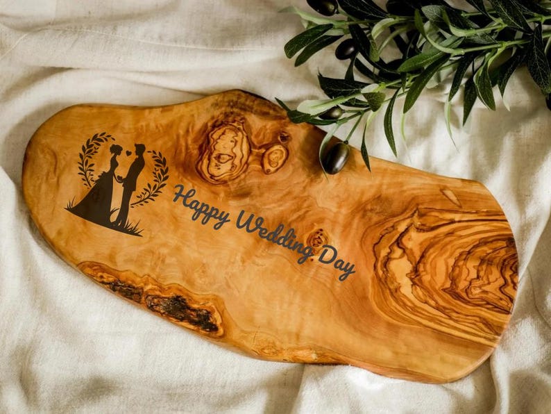 Handcrafted olive wood cutting board, custom engraved for a personal touch. Perfect for chopping, serving, or displaying in a rustic kitchen setting.