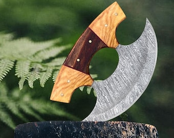 May include: A large, curved knife with a wooden handle. The blade is made of Damascus steel and has a unique pattern. The handle is made of two different types of wood, one light and one dark.