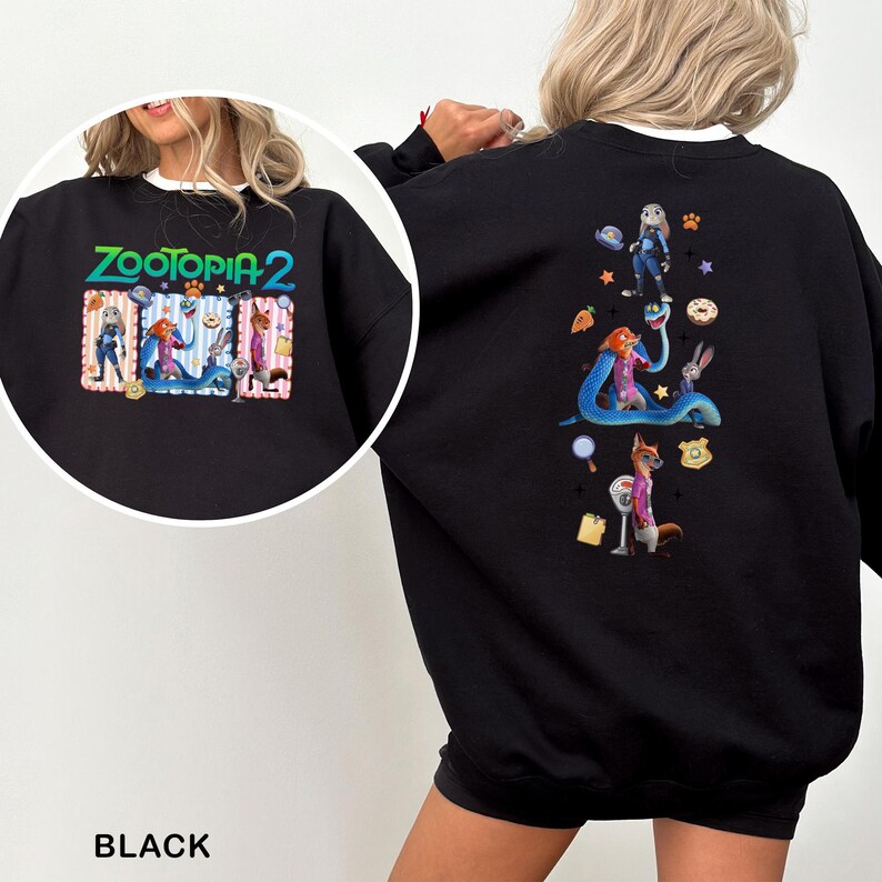 May include: Black sweatshirt featuring the text "ZOOTOPIA 2" in colorful lettering. The front graphic includes cartoon characters. The back of the sweatshirt has a larger graphic with more characters and themed objects. The sweatshirt is a crew neck style.