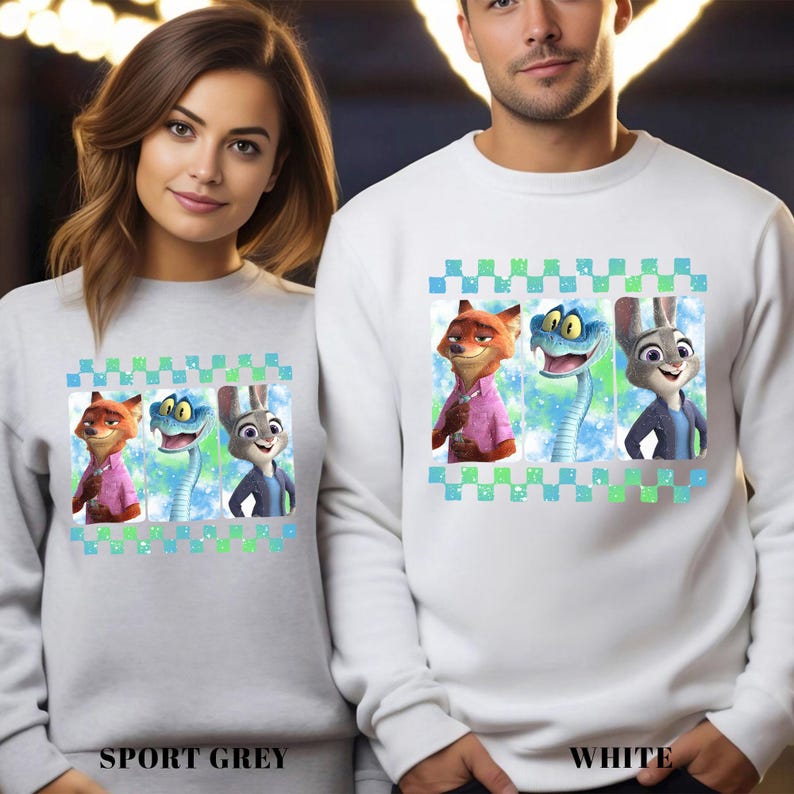 May include: Sport grey and white sweatshirts featuring a cartoon graphic of three characters from Zootopia: Nick Wilde, a snake, and Judy Hopps. The sweatshirts have a checkered pattern at the top and the text "SPORT GREY" and "WHITE" at the bottom.