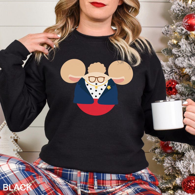 May include: Black sweatshirt featuring a cartoon character design with large ears, glasses, and a navy blue jacket. The design is set against a red and white background. The word "BLACK" is printed at the bottom of the image.