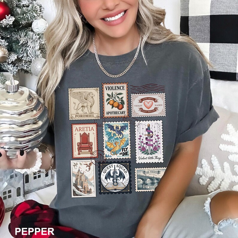 May include: Dark gray t-shirt featuring a collection of postage stamp designs. The stamps depict various illustrations, including a griffin, a throne, and a dragon. The shirt also has the word "PEPPER" printed at the bottom.