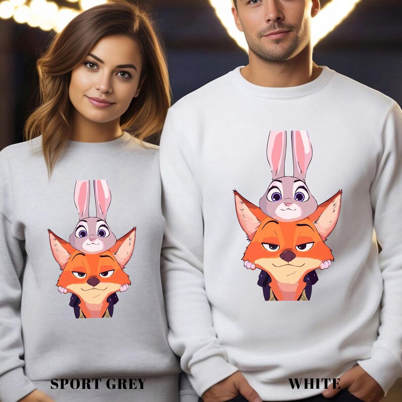 May include: Sport grey and white sweatshirts featuring a cartoon illustration of a fox, a bunny, and a rabbit. The fox is orange, the bunny is gray, and the rabbit is gray. The sweatshirts have the words "SPORT GREY" and "WHITE" printed on them.
