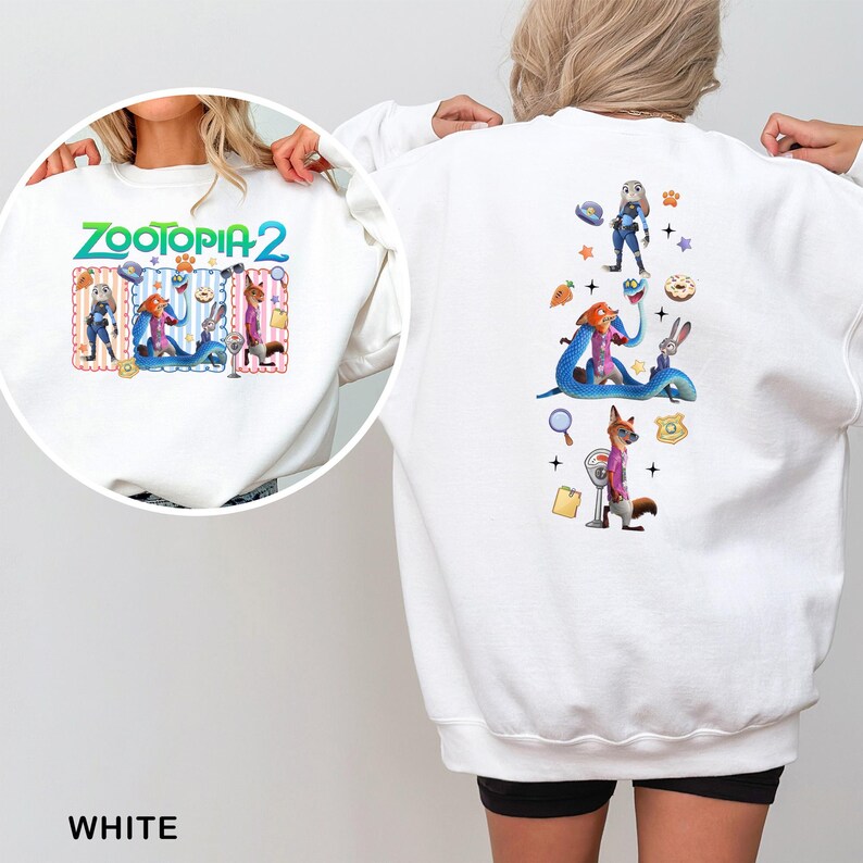 May include: White sweatshirt featuring colorful graphics from "Zootopia 2". The front displays the movie title and characters, while the back showcases additional characters and themed elements. The sweatshirt is a comfortable, casual wear item.