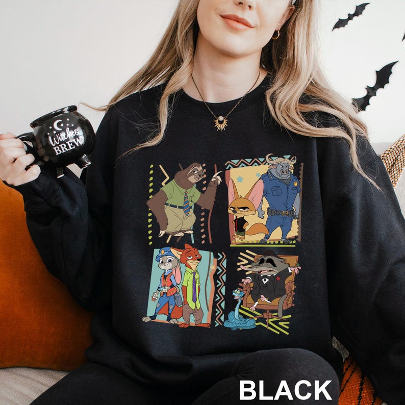 May include: Black sweatshirt featuring a colorful cartoon design of characters. The design includes a sloth, a fox, a bull, a raccoon, and other characters. The word "BLACK" is printed at the bottom of the sweatshirt.