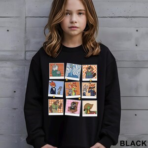 May include: Black sweatshirt featuring a collage of cartoon animal characters in polaroid-style frames. The design includes a fox in a tuxedo, a bunny, and other anthropomorphic animals. The word "BLACK" is printed at the bottom right.