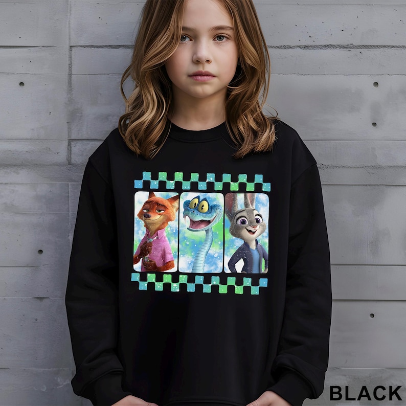 May include: Black sweatshirt featuring a colorful graphic of three characters from the animated movie Zootopia: Nick Wilde the fox, Finnick the fennec fox, and Judy Hopps the rabbit. The word "BLACK" is printed in white at the bottom right.