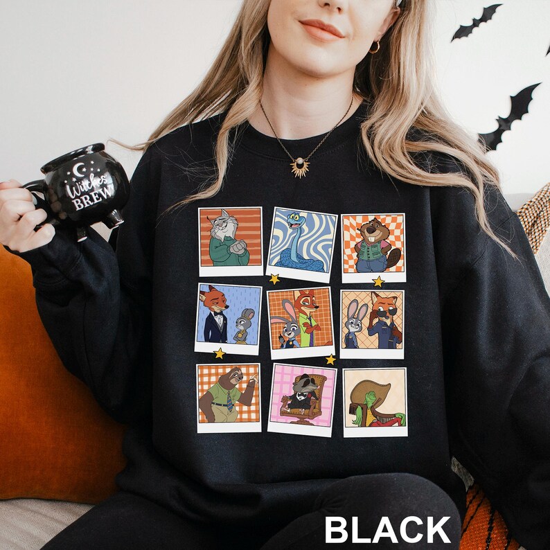 May include: Black sweatshirt featuring a grid of cartoon character portraits in retro style. The portraits are in colorful frames with a variety of animal characters. The word "BLACK" is printed at the bottom of the sweatshirt.