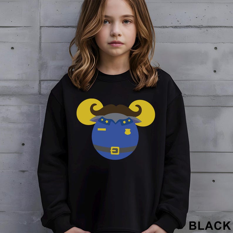 May include: Black sweatshirt featuring a cartoon ram wearing a police uniform. The ram has yellow horns, a brown mustache, and a blue uniform with stars and a badge. The word "BLACK" is printed at the bottom right.