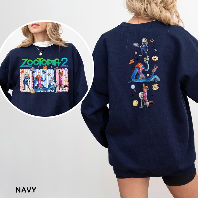 May include: Navy blue sweatshirt featuring the text "ZOOTOPIA 2" with cartoon characters on the front. The back of the sweatshirt has a colorful graphic of characters and objects from the movie. The word "NAVY" is printed at the bottom.