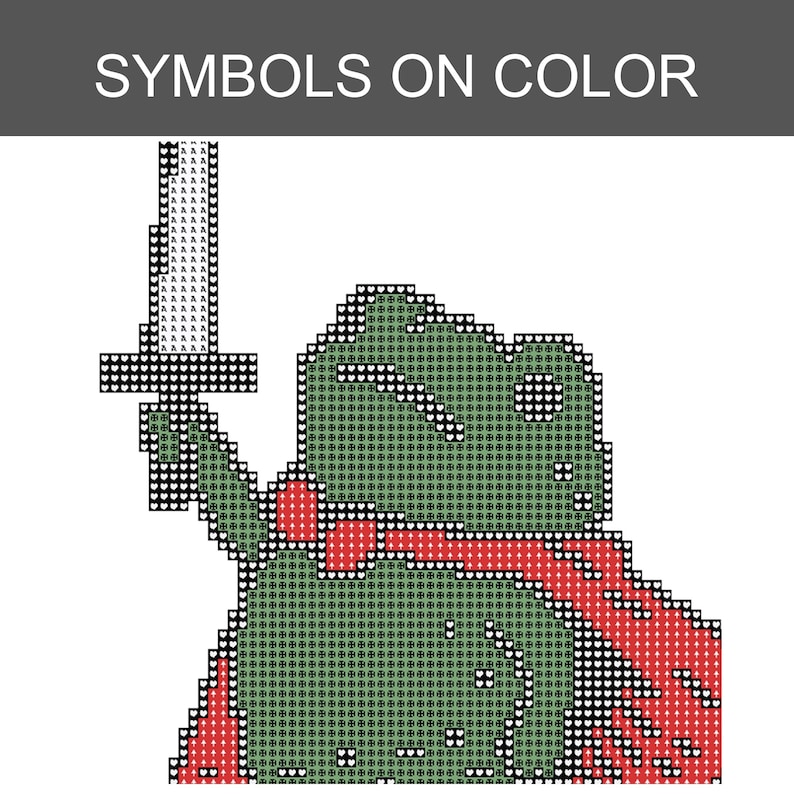 May include: A cross-stitch pattern titled SYMBOLS ON COLOR featuring a pixelated green frog character wearing a red cape and holding a sword aloft. The design uses a grid of small heart and clover symbols to represent colours in a blocky style.
