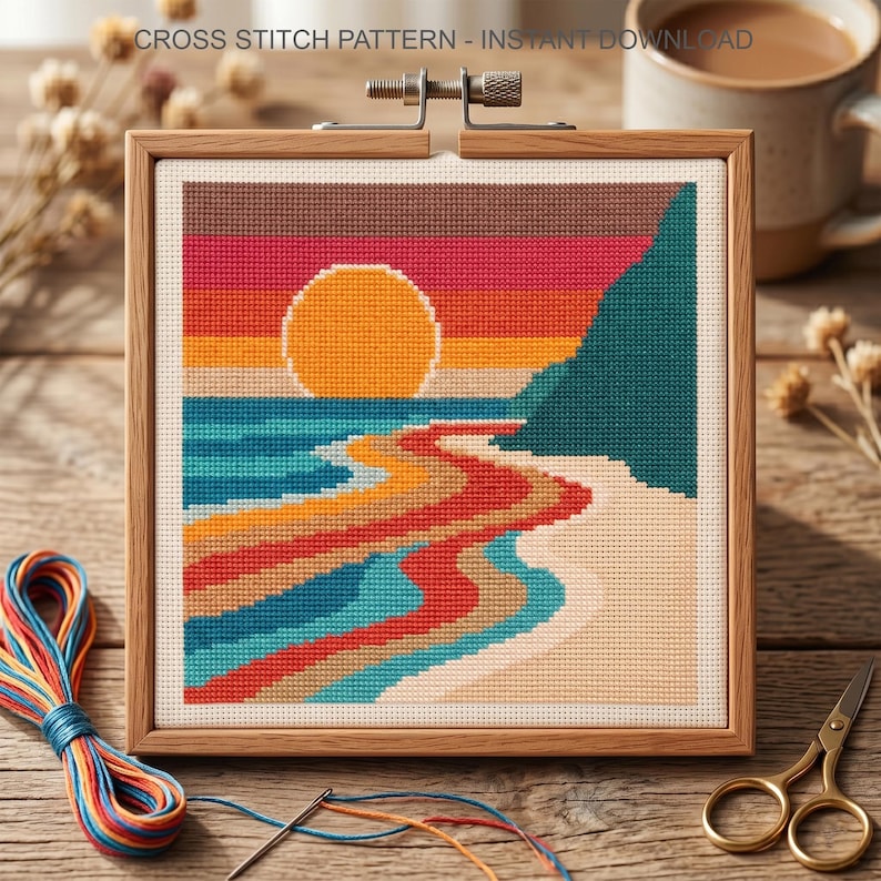 May include: A square cross stitch pattern titled CROSS STITCH PATTERN - INSTANT DOWNLOAD featuring a sunset over a beach with a large orange sun, teal cliffs, and multi-colored waves in shades of red, blue, and yellow, held in a wooden frame.