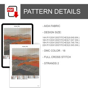 May include: A digital cross-stitch pattern titled "Amber Hills" displayed on a tablet and printed on paper. The pattern details include Aida fabric, design sizes in inches, 18 DMC colours, full cross stitch, and 2 strands.