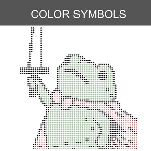 May include: A cross-stitch pattern titled COLOR SYMBOLS featuring a pixelated frog character holding a sword. The design is composed of small heart and cross symbols in black, white, and red, creating a grid-like image of a frog warrior.