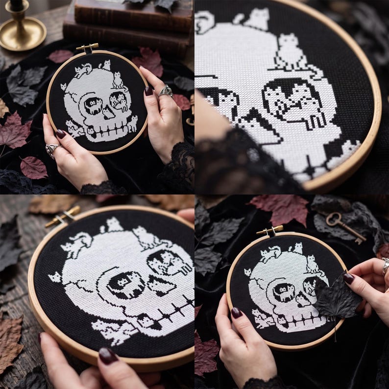 May include: A circular wooden embroidery hoop containing a black fabric piece with a white cross-stitch design of a human skull. The skull is composed of multiple small cat figures, with cats positioned on the cranium, within the eye sockets, and along the jawline.