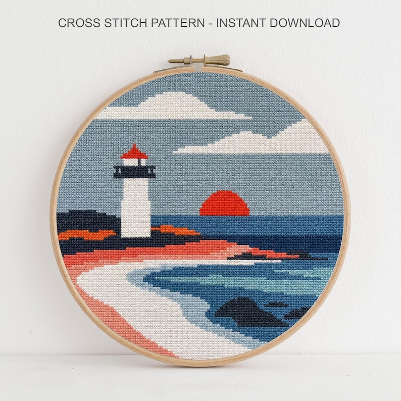 May include: A cross-stitch pattern in a wooden hoop depicts a coastal scene with a lighthouse, ocean, and sunset. The text "CROSS STITCH PATTERN - INSTANT DOWNLOAD" is at the top. The design features shades of blue, red, and white.