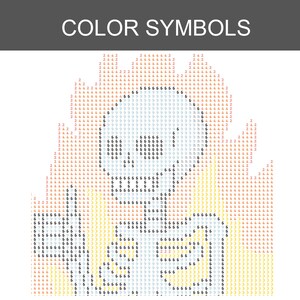 May include: A diamond painting pattern labeled COLOR SYMBOLS featuring a grid of numbers and letters. The design depicts a skull surrounded by flames, using a color-coded system of black, red, orange, and yellow symbols on a white background.
