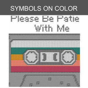 May include: A cross-stitch pattern featuring a cassette tape design with horizontal stripes in teal, orange, red, and pink. The text "Please Be Patie With Me" is displayed in black pixelated lettering above the cassette graphic on a white background.