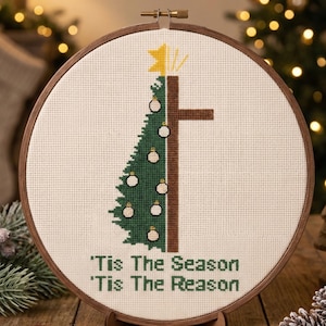 May include: A cross-stitch design in a wooden hoop. The pattern shows a green Christmas tree and a brown cross. The text reads "'Tis The Season 'Tis The Reason". The top of the image reads "CROSS STITCH PATTERN - INSTANT DOWNLOAD".