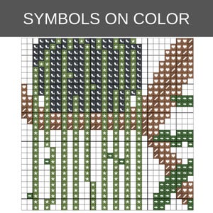 May include: A cross-stitch pattern chart titled SYMBOLS ON COLOR featuring a grid with various symbols including stars, hearts, and arrows in shades of dark green, light green, and brown, organized into a structured design for needlework.