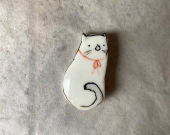 White cat with a ribbon- a porcelain brooch