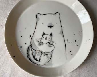 Bear holding his cat - a porcelain plate